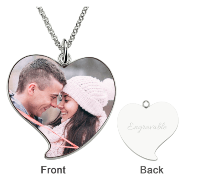 Sterling silver heart-shaped photo pendant with a rollo chain, showing a couple in winter clothing touching foreheads on the front and an engravable blank back.