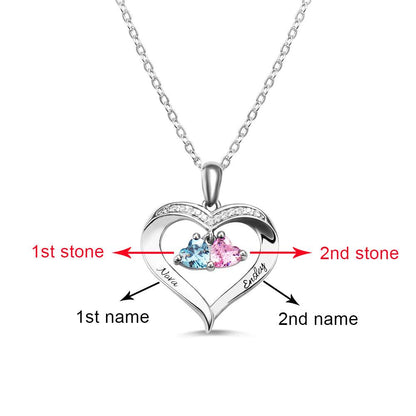 A heart-shaped silver necklace with two heart-shaped birthstones, marked to indicate the first and second stones and engraved names "Nova" and "Easley."