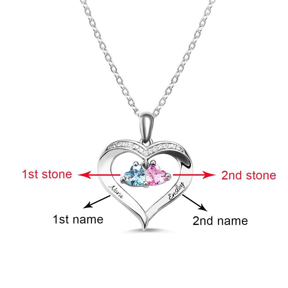 A heart-shaped silver necklace with two heart-shaped birthstones, marked to indicate the first and second stones and engraved names "Nova" and "Easley."