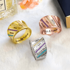 Three personalized rings in gold, silver, and rose gold with engraved names and colorful birthstones, featuring "Always & Forever" inscriptions, displayed elegantly.