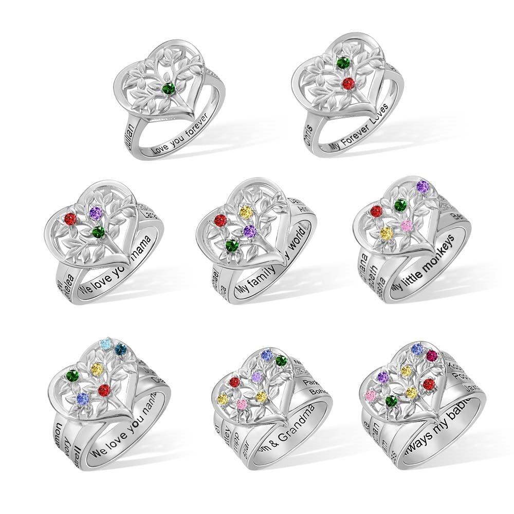 Eight silver rings with heart and floral designs, each featuring colorful gems and engraved names like "Love you forever," "My family, my world," and "We love you mama."