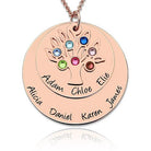 A rose gold family tree necklace with two disks: a smaller disk with the names Adam, Chloe, and Elie, and a larger disk with the names Alicia, Daniel, Karen, and James, adorned with colorful gemstones.