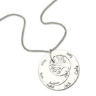 A silver circular pendant necklace with a tree design in the center, engraved with the names "Jessica, Peter, Tom, Andrew, Nate, Jack, April, Carla, Sam."