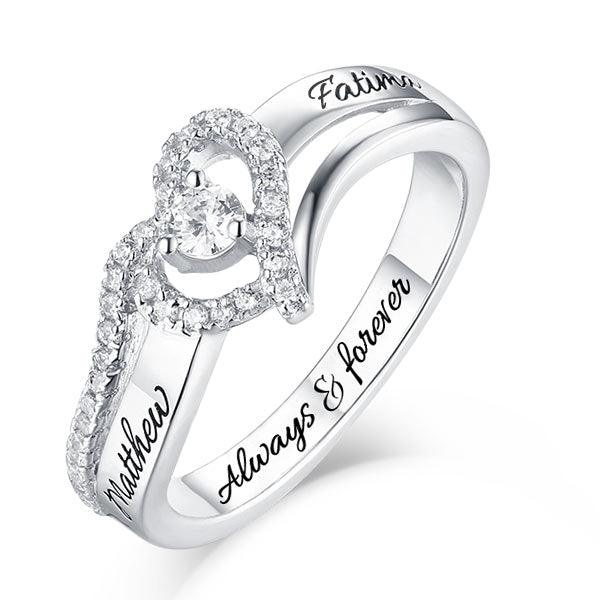 Customized silver ring with a heart-shaped halo of diamonds and engraved names 'Matthew' and 'Fatima', and 'Always & Forever'.