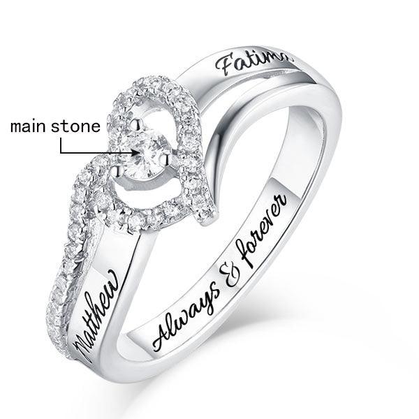 Silver ring with 'Matthew' and 'Fatima' engraved, a diamond heart halo, and 'main stone' label pointing to the center.