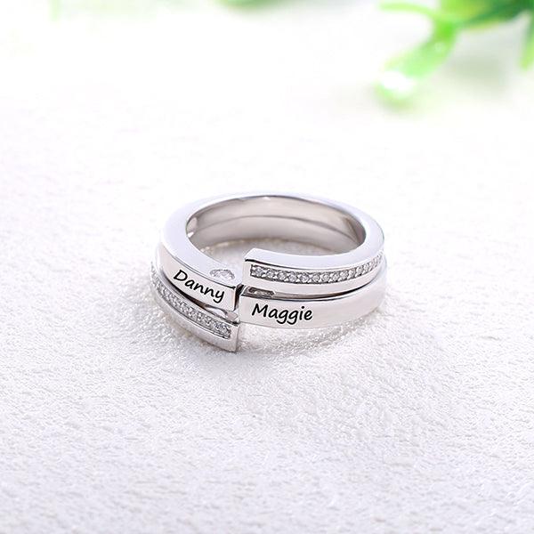 Sterling silver personalized couple rings set with custom engraved names, Danny and Maggie. Elegant design with embedded stones, symbolizing eternal love.