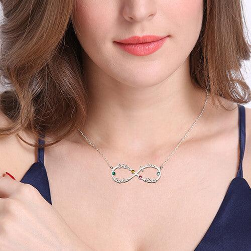 Woman wearing a silver infinity necklace with engraved names Chloe, Julian, Sophia, Katie