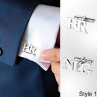 Silver 'BR' cufflink on a white shirt sleeve, with 'NG' cufflink shown as Style 1.