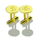 Pair of gold cufflinks with monogrammed initials 'L' and intertwined 'L' displayed on a reflective surface.