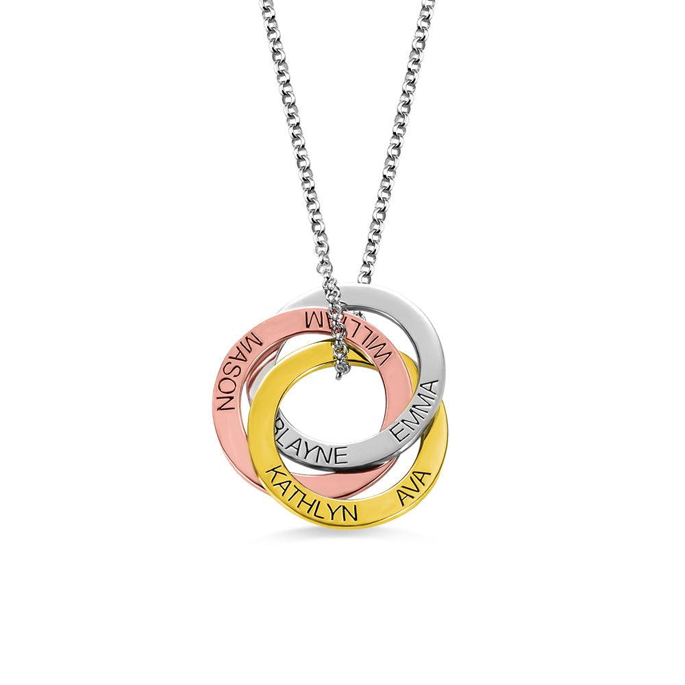 A necklace with three interlocking rings in rose gold, silver, and gold. Each ring is engraved with names: MASON, WILLIAM, EMMA, KATHLYN, AVA, and BLAYNE.