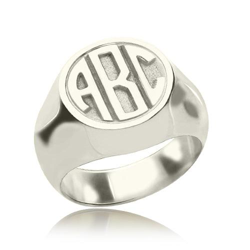 Silver signet ring with 'ABC' block monogram engraving on a circular face, polished finish.