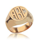 Rose Gold signet ring with 'ABC' block monogram engraving on a reflective surface.