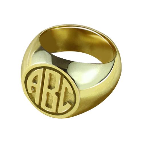 Bold gold signet ring with 'ABC' block monogram carving on a solid band.