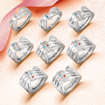 Eight silver intertwined rings with engraved names and colorful gemstones, featuring phrases like "Mommy's Princess," "My Whole Heart," "Family is forever," and "Best Grandma."