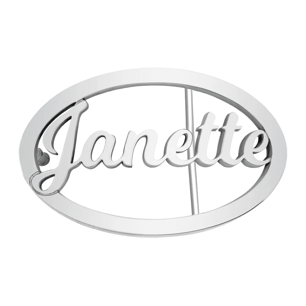 Shiny silver oval belt buckle featuring the cursive name 'Janette' in the center, on a white background."