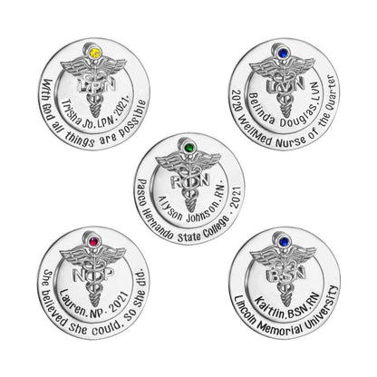 Assorted custom nursing pins with caduceus and colored gems, personalized engravings.