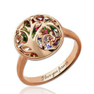 A rose gold ring with a tree of life design featuring multicolored gemstones. The inside of the band is engraved with the words "I love you forever."