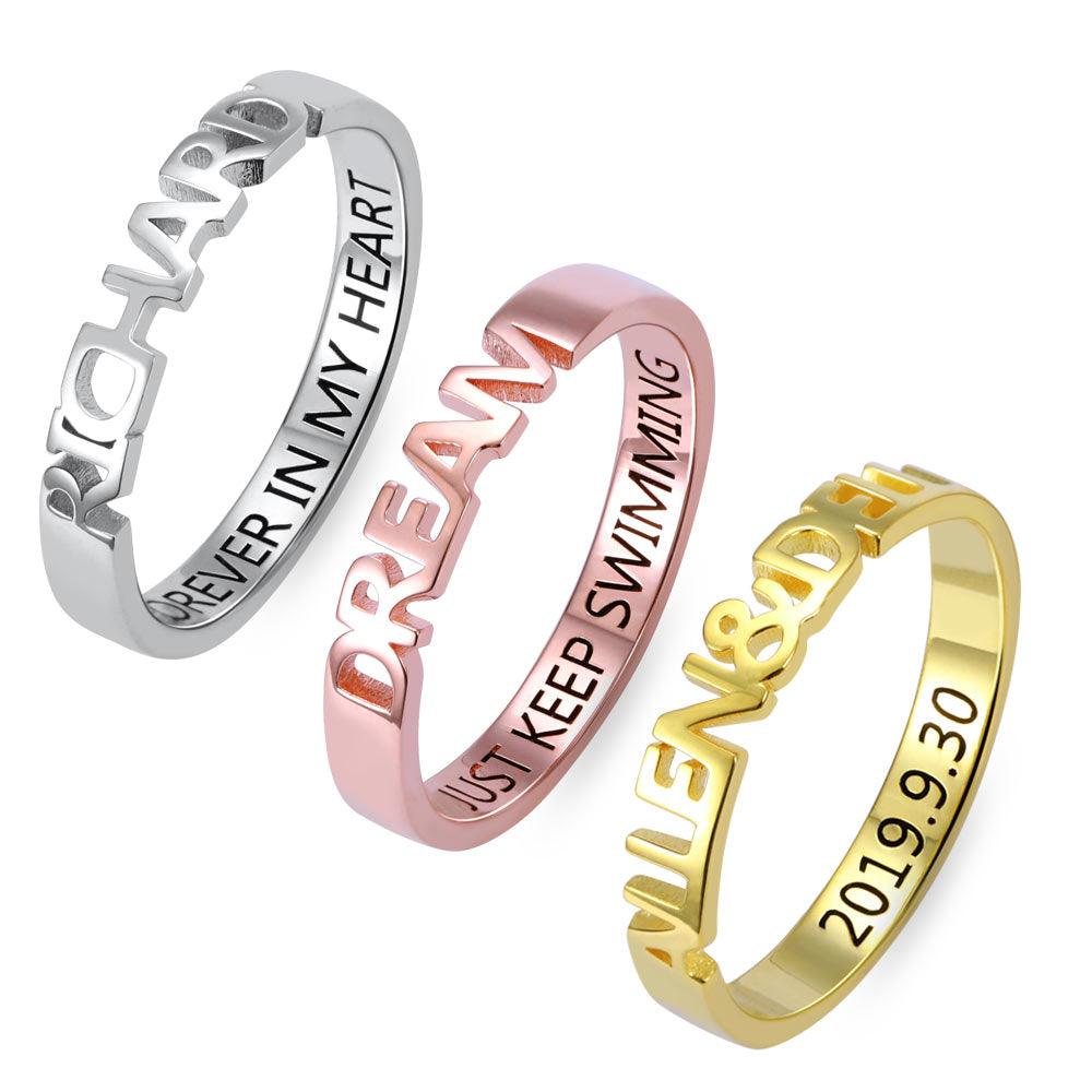 Three rings in silver, rose gold, and gold with cut-out lettering. The silver ring reads "RICHARD FOREVER IN MY HEART," the rose gold ring reads "DREAM JUST KEEP SWIMMING," and the gold ring reads "ALLEN & DEL 2019.9.30."