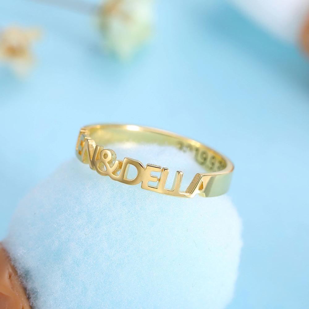 A gold ring with cut-out lettering that reads "ALLEN & DELLA." The inside of the ring is inscribed with the date "2019.9.30."