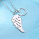 Silver necklace with a wing-shaped charm and a heart, both adorned with rhinestones, against a blue background.