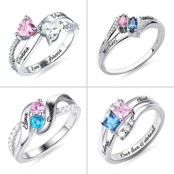 Four silver rings with heart,  square, round and marquis -shaped stones, each engraved with different names and phrases like "Love you forever" and "Our love is eternal."