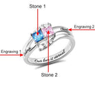 Silver ring with square-cut blue and pink stones labeled "Stone 1" and "Stone 2." Engravings "Selena" and "Claud" are on the sides, with "Our love is eternal" inside the band.