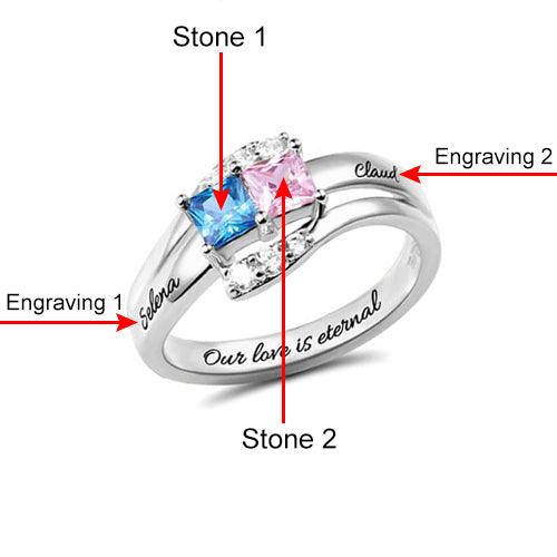 Silver ring with square-cut blue and pink stones labeled "Stone 1" and "Stone 2." Engravings "Selena" and "Claud" are on the sides, with "Our love is eternal" inside the band.