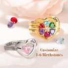 Two customizable heart rings in gold and silver, featuring 1-6 multicolored birthstones with names like Thomas, Justin, Bella.