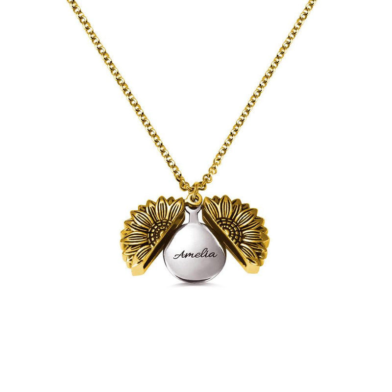 A gold sunflower-shaped locket necklace, opened to reveal the name "Amelia" engraved inside, displayed against a white background.