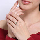 Woman wearing a Sterling Silver Infinity Symbol Ring on her hand, showcasing its elegant design and polished finish, perfect for expressing eternal love.