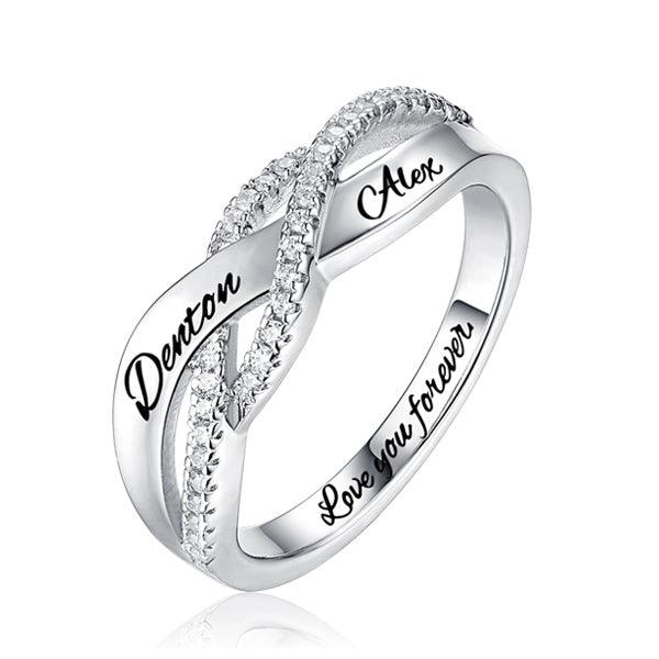 A silver infinity ring with diamond accents, engraved with the names "Denton" and "Alex" on the outer band and "Love you forever" on the inner band.