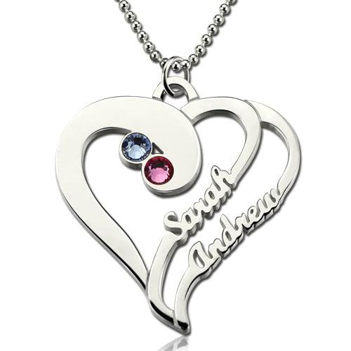 Silver heart-shaped pendant with blue and pink gemstones, engraved with "Sarah" and "Andrew," on a beaded chain.